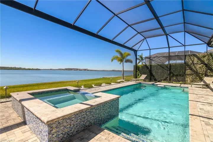 Oversized pool and spa includes swim jet for lap swimming, custom glass tile work, salt-water filtration system, natural gas heater, and automatic water filling system.
