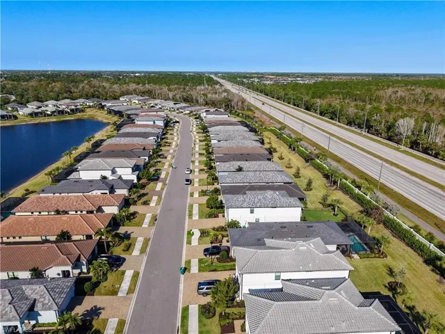Drone / aerial view with a residential view and a water view