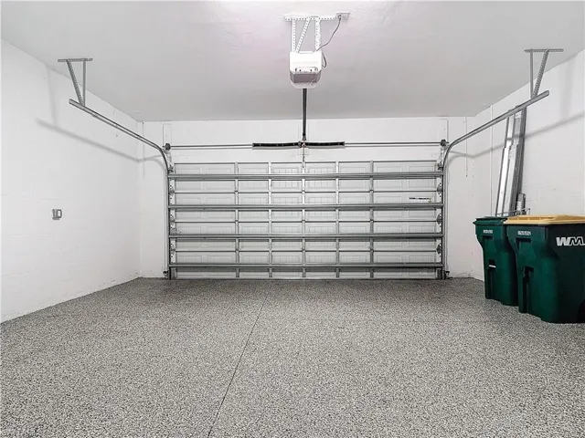 Garage with a garage door opener and concrete block wall