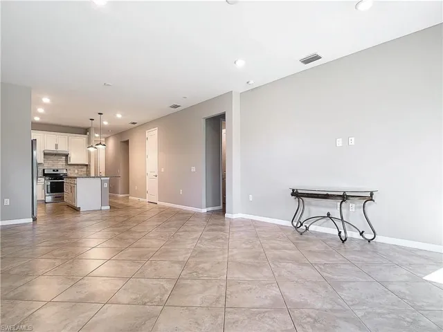 Living area featuring recessed lighting, baseboards, visible vents, and light tile patterned flooring