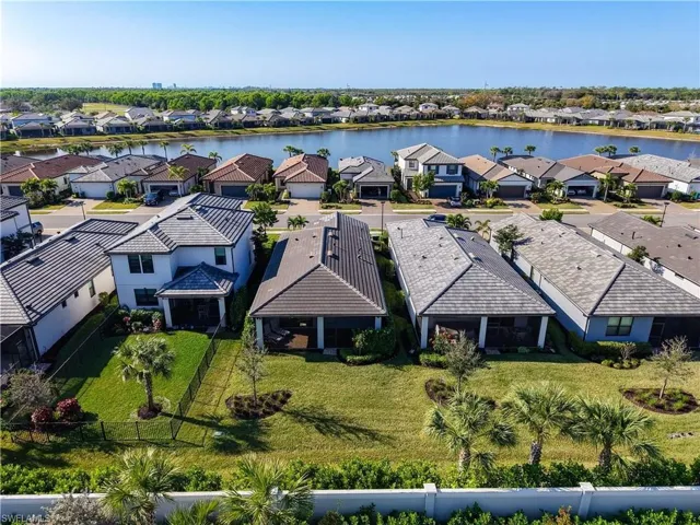 Birds eye view of property with a residential view and a water view