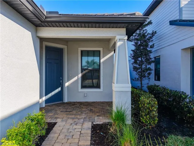 Property entrance featuring stucco siding