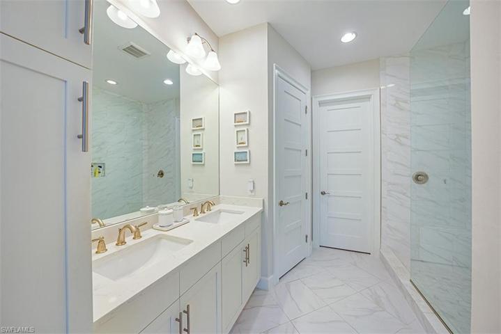 The master bathroom features dual sinks, quartz countertops, spacious walk-in shower, and large walk-in closet.