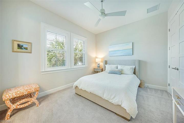 The guest room with en suite bathroom features plantation shutters.
