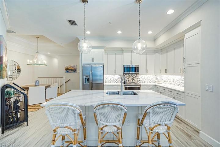 Kitchen upgrades includes quartz countertops and tile backsplash.