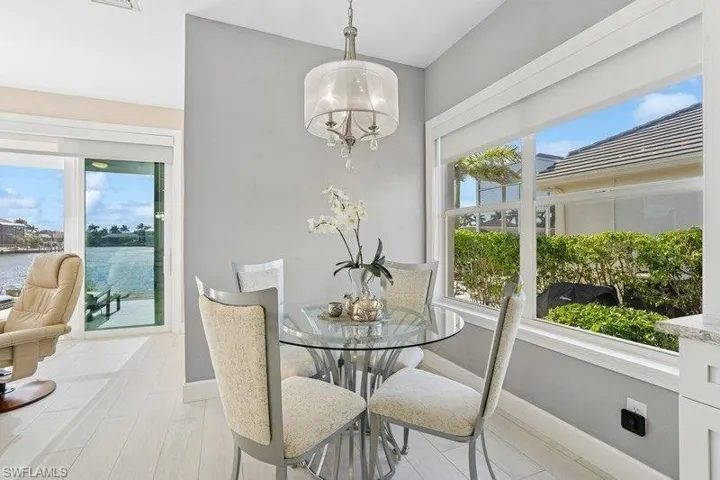 Dining space with healthy amount of natural light, baseboards, and a chandelier