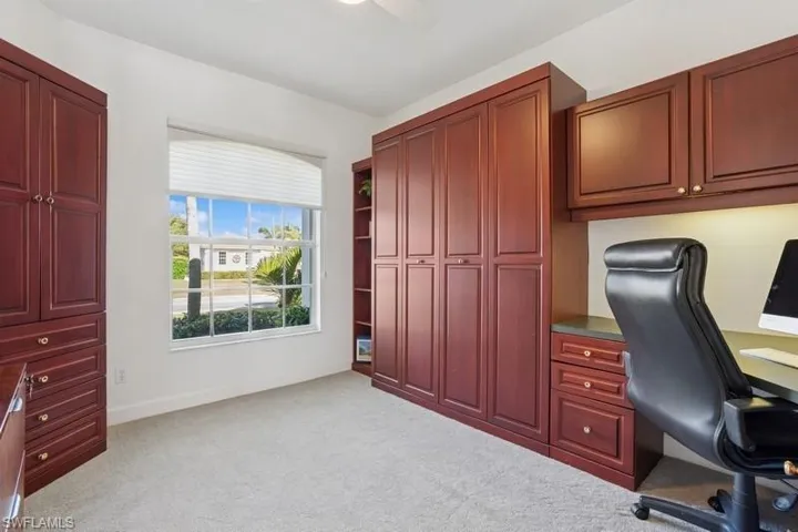 Office space featuring ceiling fan, carpet flooring, and baseboards