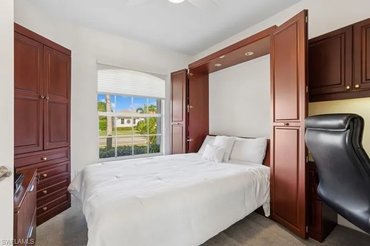 Bedroom with ceiling fan and carpet floors