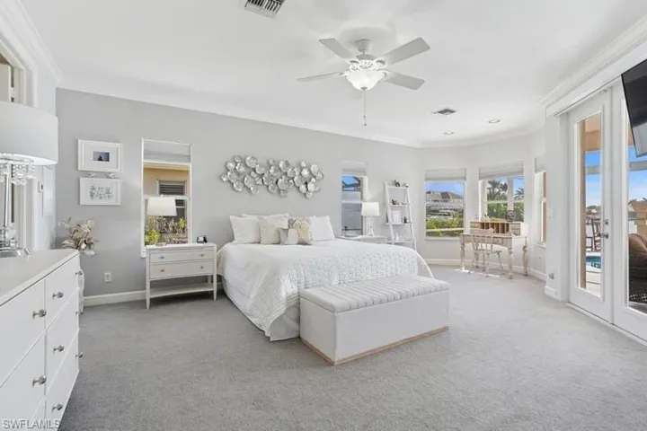 Bedroom featuring access to exterior, crown molding, carpet floors, baseboards, and ceiling fan