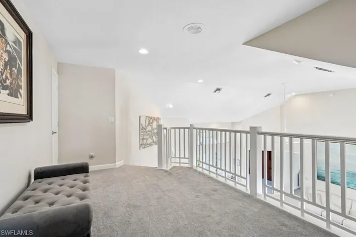Sitting room with recessed lighting, visible vents, carpet floors, and lofted ceiling