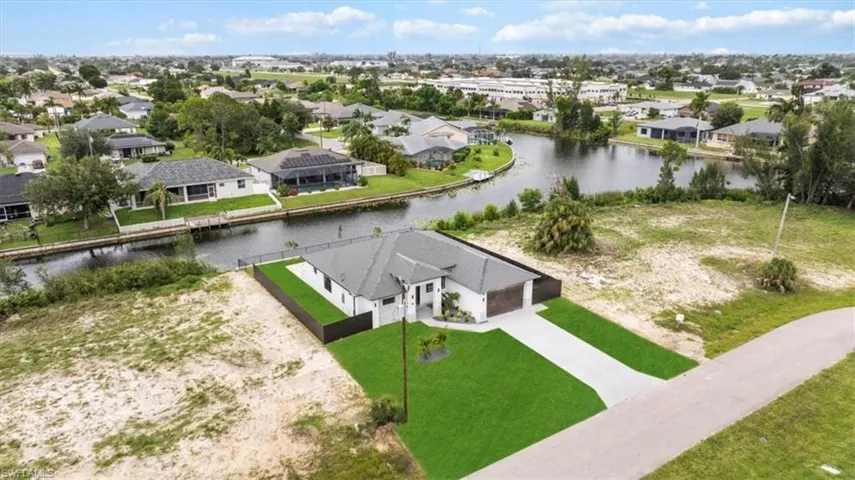 Aerial perspective of suburban area featuring a large body of water
