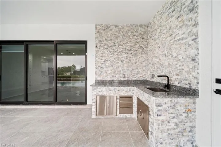 View of patio / terrace featuring exterior kitchen and a sink