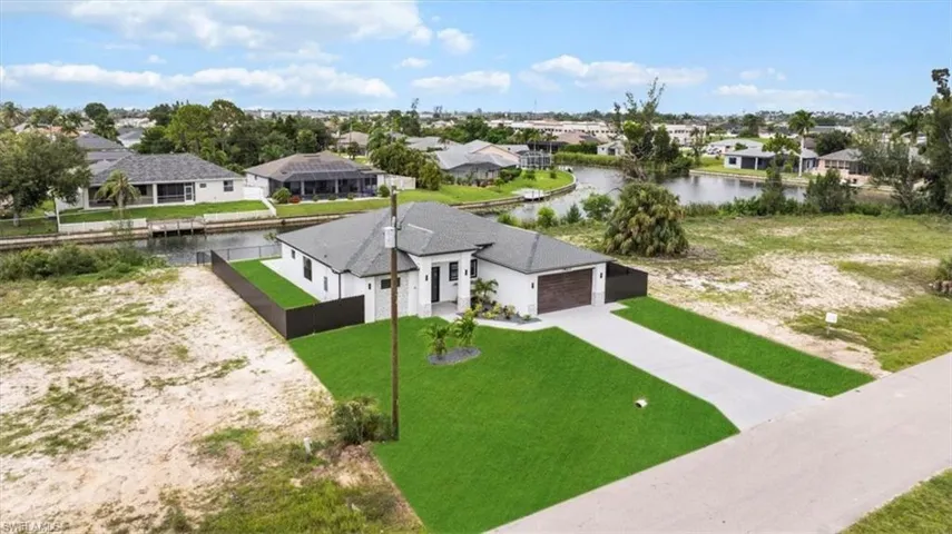 Aerial view of residential area featuring a nearby body of water