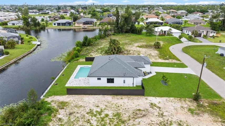 Aerial perspective of suburban area with a nearby body of water