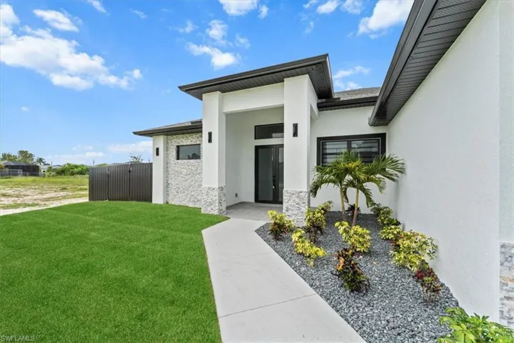 Property entrance featuring stucco siding and stone siding
