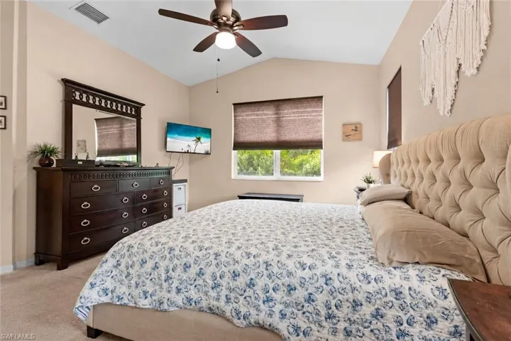 Primary bedroom with vaulted ceilings