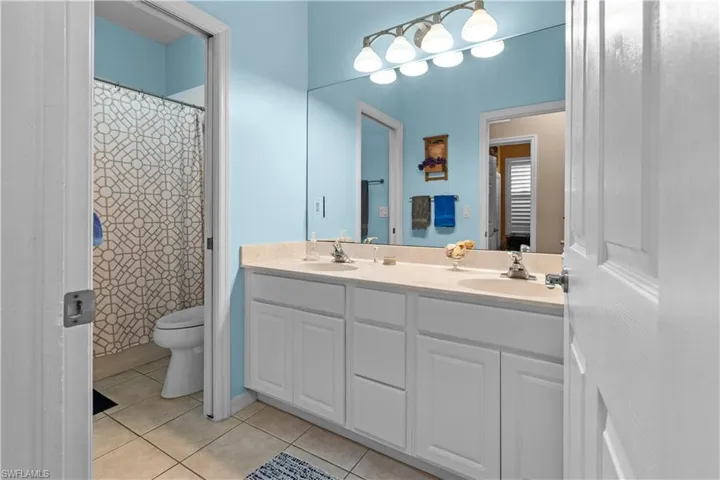 Guest bathroom with shower/tub combo, separate water closet and double sinks