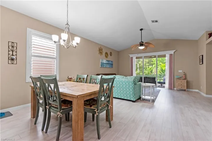 Great room featuring light wood-type flooring, vaulted ceiling, and plenty of natural light