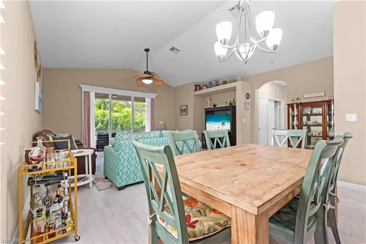 Dining area with arched walkways and vaulted ceilings