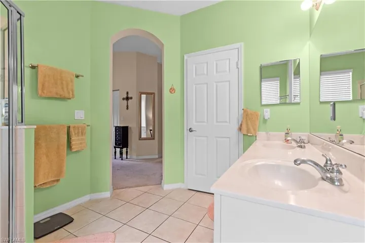 Primary bathroom featuring double sinks and separate water closet