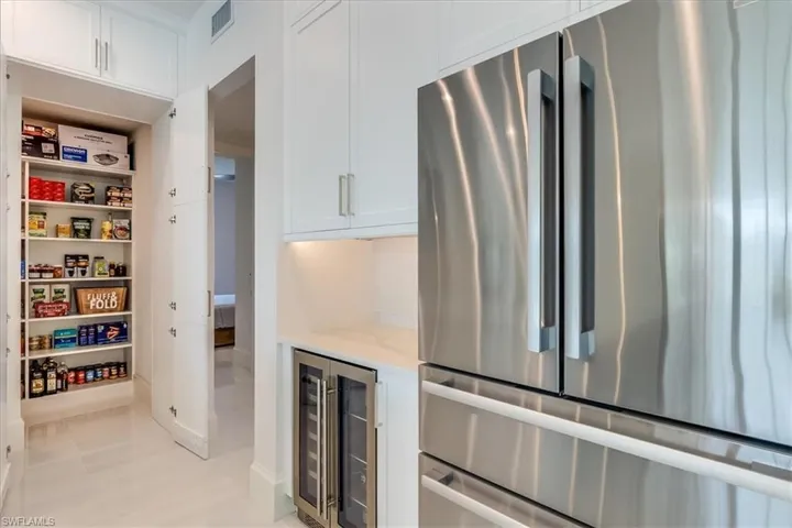 Walk in (and wrap around) hidden pantry