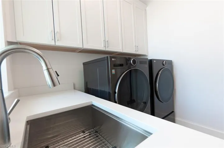 Laundry sink under window in laundry room