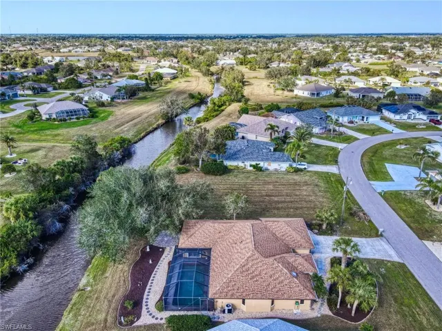 Birds eye view of property with a water view