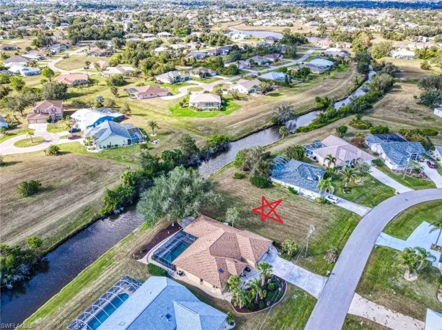 Birds eye view of property with a water view