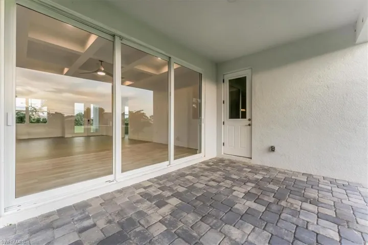 Unfurnished sunroom featuring a ceiling fan