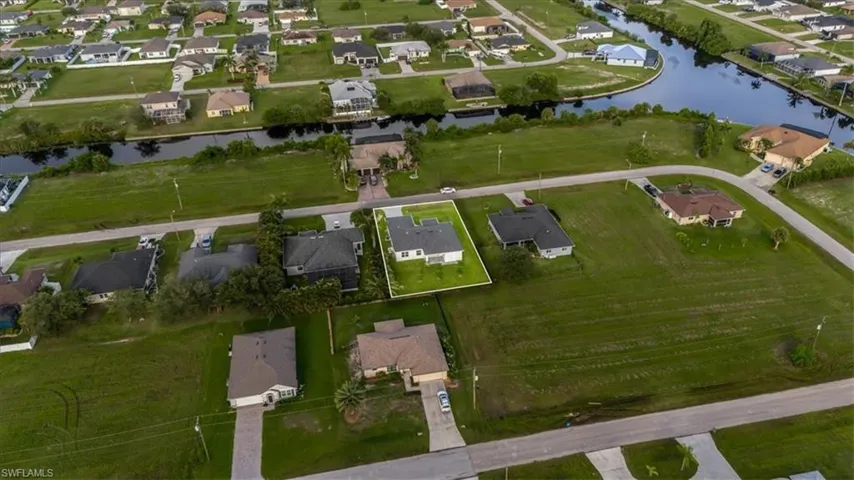 Aerial view of property's location featuring nearby suburban area and a large body of water