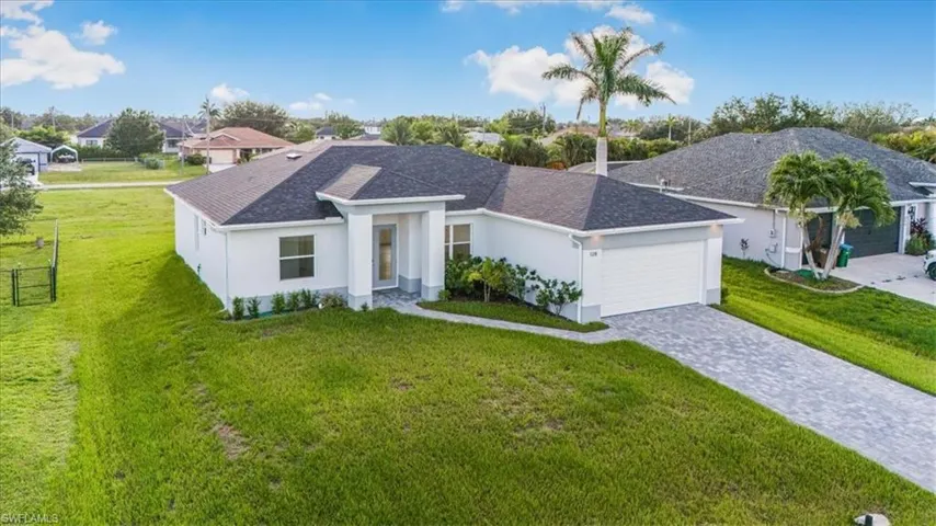 Single story home with an attached garage, roof with shingles, stucco siding, decorative driveway, and a residential view