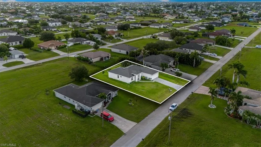 Aerial perspective of suburban area featuring property boundaries highlighted