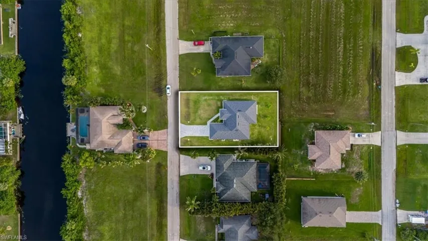 Aerial view of property's location featuring a nearby body of water