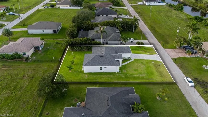 Aerial perspective of suburban area with a nearby body of water