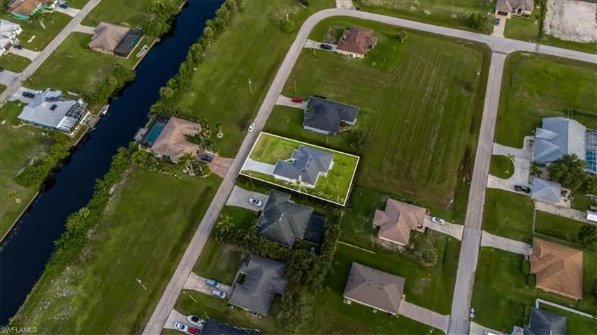 Aerial overview of property's location featuring a large body of water and nearby suburban area
