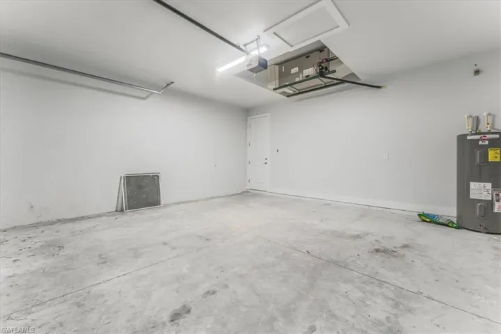 Garage with water heater and a garage door opener