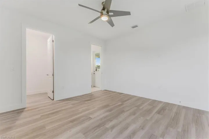 Unfurnished room with light wood finished floors and a ceiling fan