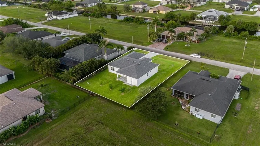 Aerial perspective of suburban area with a large body of water