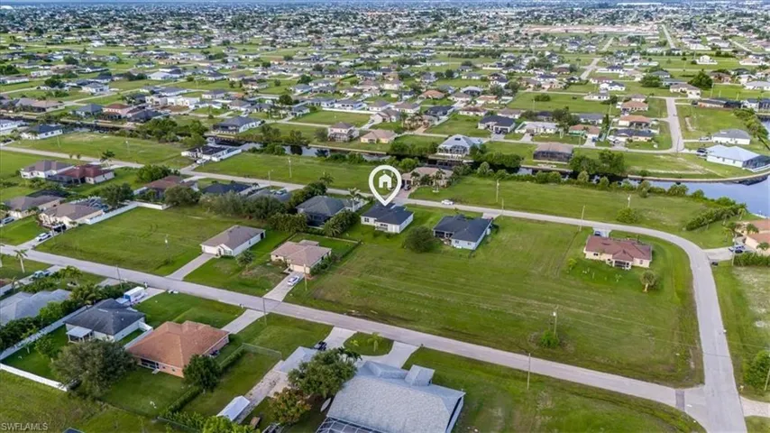 View of property location with nearby suburban area and a large body of water