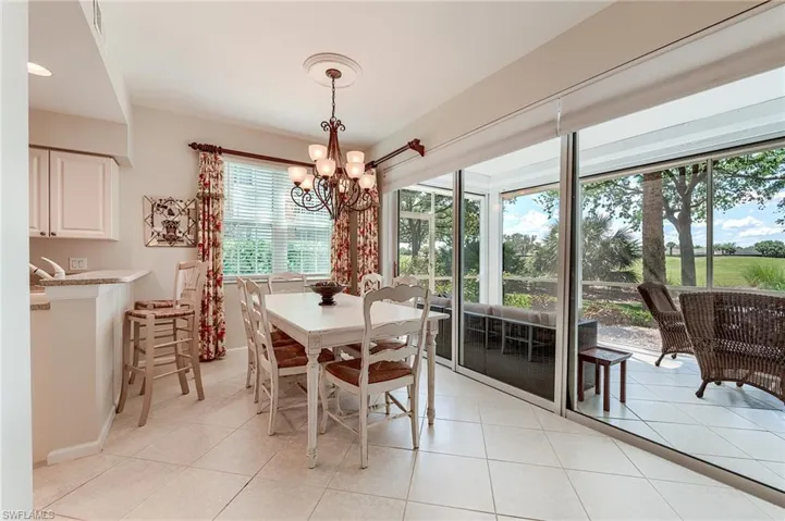 Dining area featuring light tile patterned floors and a chandelier