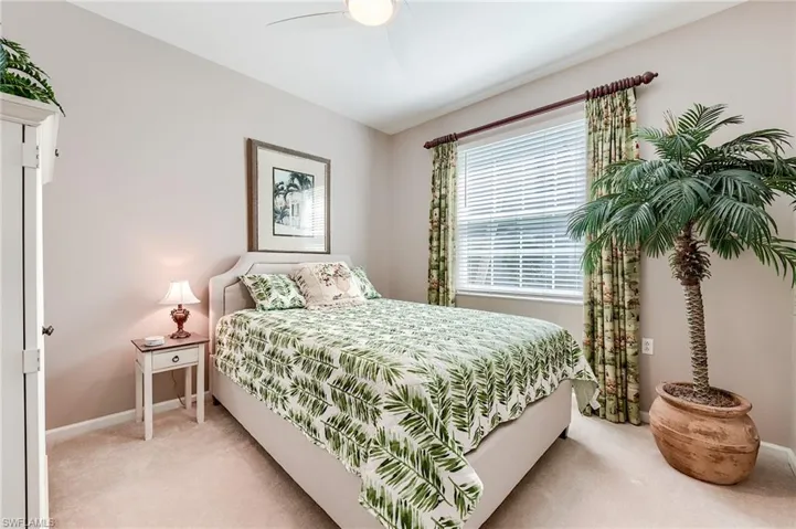 Den used as third bedroom featuring baseboards, light colored carpet, and ceiling fan