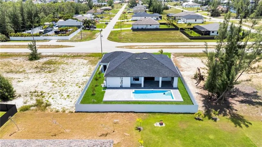 Aerial perspective of suburban area featuring a pool