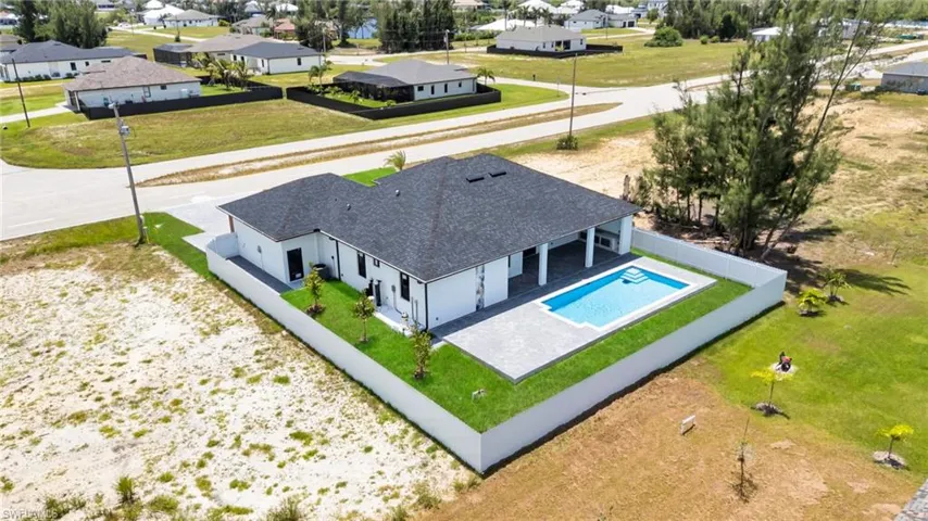 Aerial perspective of suburban area featuring a pool area