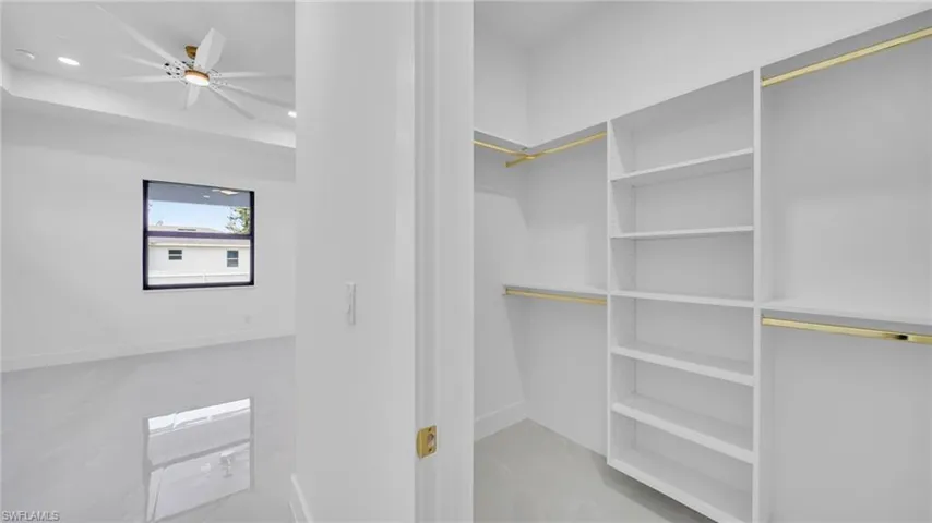 Spacious closet with a ceiling fan