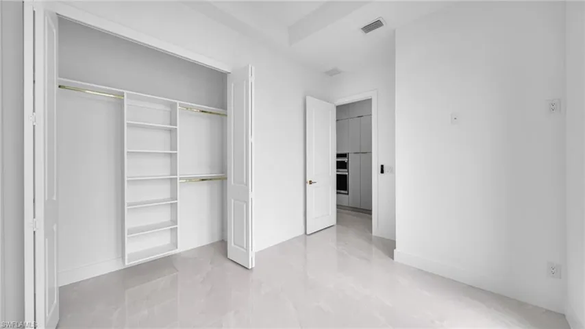 Unfurnished bedroom featuring a closet and baseboards