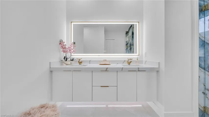 Bathroom with double vanity and a shower with door