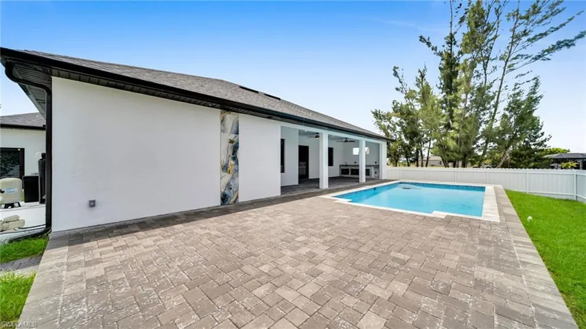 View of pool with a patio area, ceiling fan, and a fenced backyard