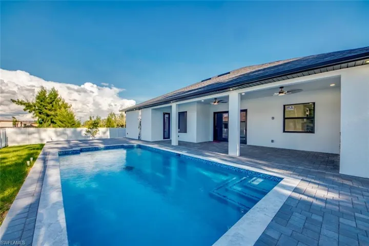 View of swimming pool featuring a patio, ceiling fan, and a fenced backyard