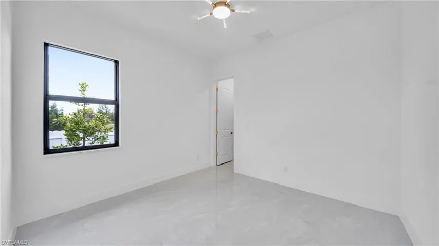 Empty room featuring baseboards