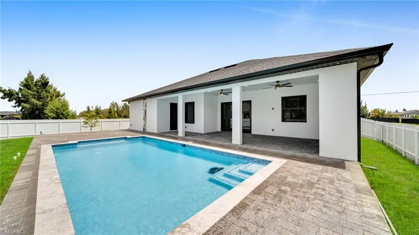 View of pool with a fenced backyard, a patio, and ceiling fan